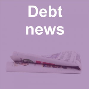 Debt news title and newspaper on purple background
