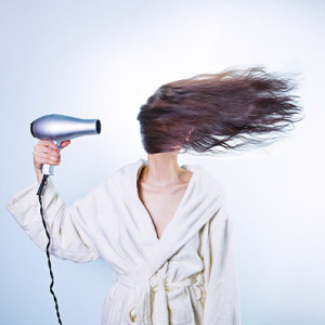 hair dryer drying girl's hair